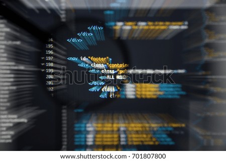 Real Html code developing screen. Programing workflow abstract algorithm concept. Lines of Html code visible under magnifying lens with moviment effect.