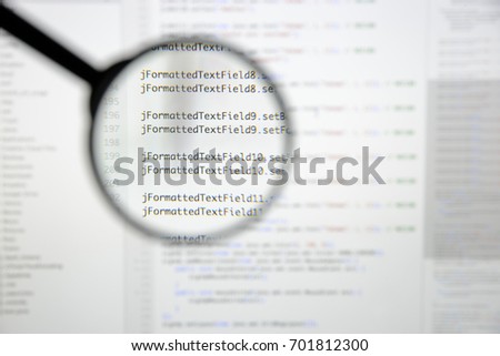 Real Java code developing screen. Programing workflow abstract algorithm concept. Lines of Java code visible under magnifying lens.
