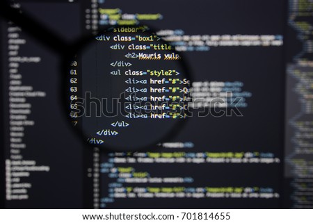 Real Html code developing screen. Programing workflow abstract algorithm concept. Lines of Html code visible under magnifying lens.