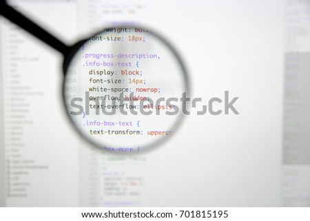 Real css code developing screen. Programing workflow abstract algorithm concept. Lines of css code visible under magnifying lens.