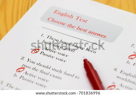 English test with red pen on desk Royalty-Free Stock Photo #701836996
