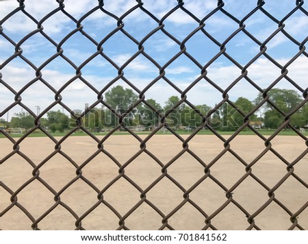 Close up wire fence over baseball field background. / With Copy Space