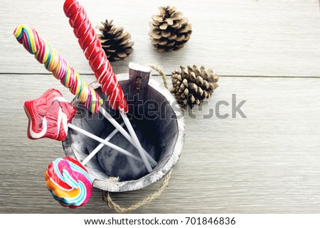 Colorful lollipops, candy canes and sweet candies mix in small W
