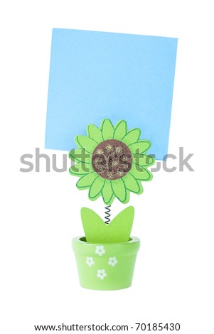 Green Wooden Flower Holds a Blue Note with Isolated White Background