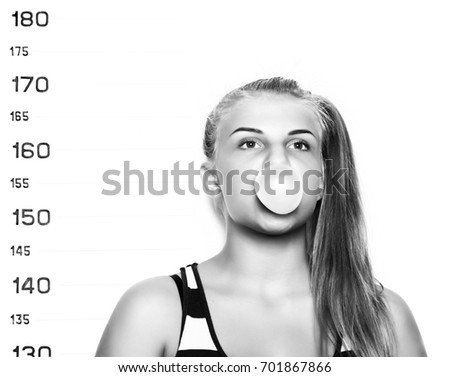Young beautiful blonde woman chewing gum and blowing bubbles Criminal Mug Shots