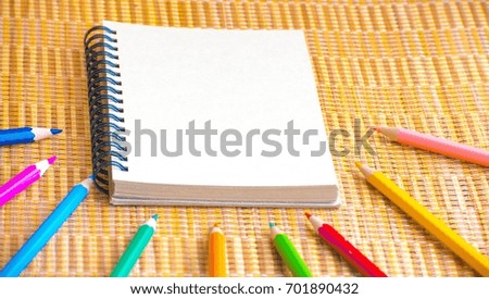 Notepad with pencil on wood board background. using wallpaper or background for education, business photo. Take note of the product for book with paper and concept or copy space.