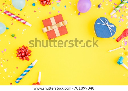 Colorful celebration pattern with various party confetti, balloons, gift box on yellow background. Flat lay