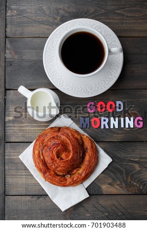 Cup of coffee, milk and wooden letters words GOOD MORNING on wooden table background. Top view, copy space. Concept breakfast