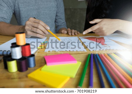 young fashion designer work with fabric cloth on the wood table or graphic designer