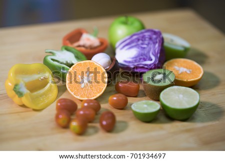 Colorful of fruit and vegetable on wooden table. Pepper, chili, lime, tomatoes, Cabbage, kiwi, multi healthy fruit on background. Royalty high quality free stock image.