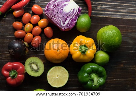 Colorful of fruit and vegetable on wooden table. Pepper, chili, lime, tomatoes, Cabbage, kiwi, mangosteen, multi healthy fruit on background. Royalty high quality free stock image.