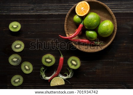 Colorful of fresh fruits and vegetable on wooden table. Chili, lime, tomatoes, Cabbage, kiwi, , multi healthy fruits on background. Royalty high quality free stock image.