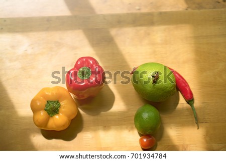 Colorful of fresh fruits and vegetable on wooden table.Pepper, chili, lime, tomatoes, multi healthy fruits on background. Royalty high quality free stock image.
