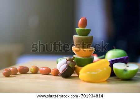 Colorful of stacking fruits on wooden table . Pepper, chili, lime, tomatoes, kiwi, apple, mangosteen, multi healthy fruits on background. Royalty high quality free stock image.