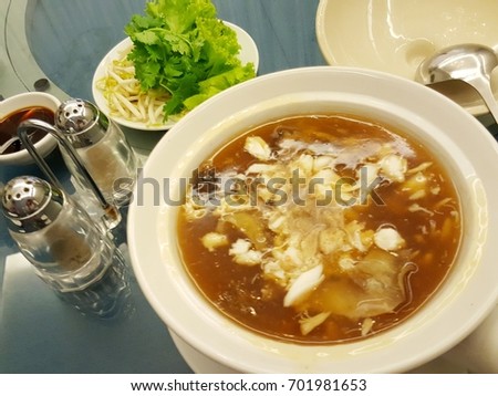 shark's fin soup, Tasty Chinese food style, Chinese Shark's Fin Soup with brown sauce serve in white bowl. Royalty-Free Stock Photo #701981653