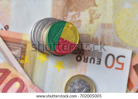 euro coin with national flag of benin on the euro money banknotes background. finance concept