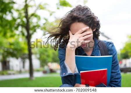 View of a Young student woman having a headache due to stress and anxiety - Burn out at school