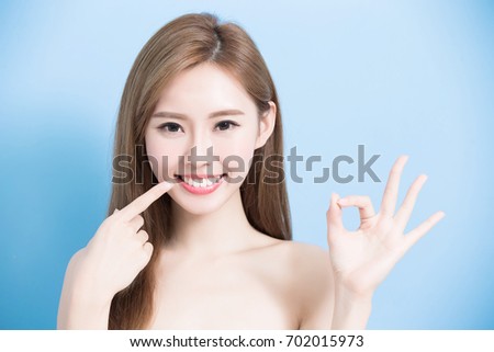 beauty woman show her tooth and smile on the blue background