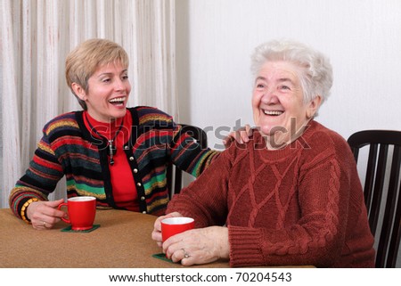 Senior and mature womans drinking caffee and laughing