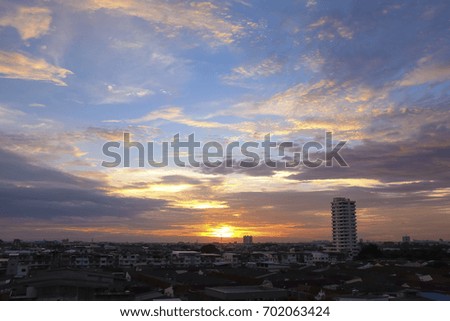 Sunset view of a blue sky with cloud over city downtown with houses and office buildings