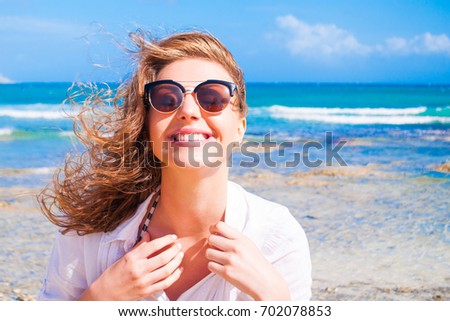Woman in sunglasses on a sunny beach