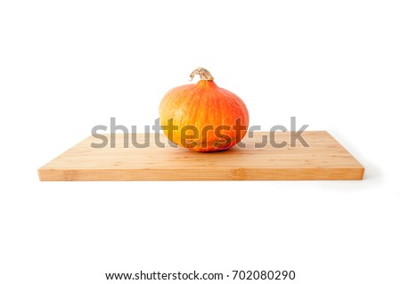 One pumpkin on a bamboo board