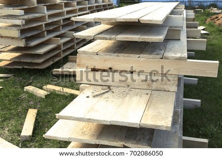 the hammered together and prepared wooden boards for the base of the house in the village
