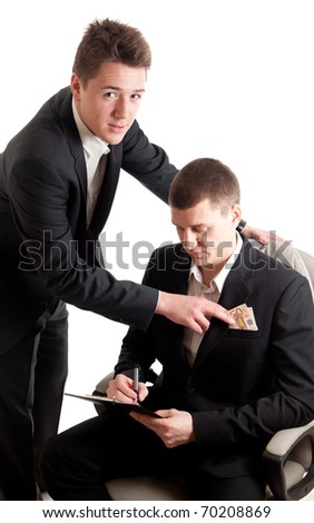 a young businessmen signing a contract while receiving money
