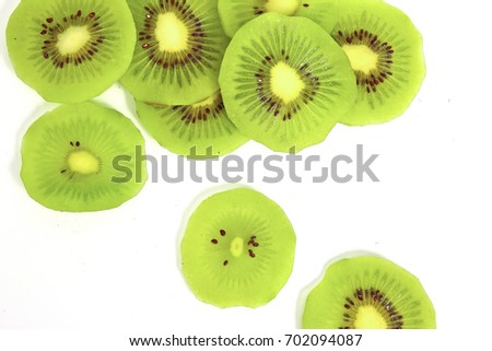 fresh kiwi fruit cut into thin slices an isolated on white background. Royalty-Free Stock Photo #702094087
