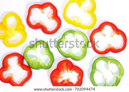 Green , yellow and red  Fresh bell pepper [capsicum] cut into thin slices isolated on white background. Royalty-Free Stock Photo #702094474