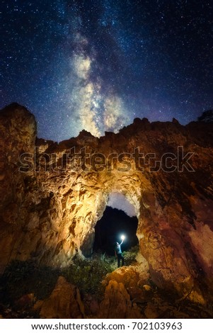 Selfie photo inside a rock arch with milky way