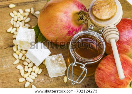 Honey, apples and pomegranates on wood deck for Rosh Hashana celebration. Honey garnet apples Jewish New Year