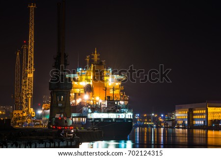 Container ship by night in port of Gdynia- Poland, Europe