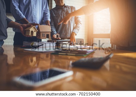 Business meetings of real estate brokers and company presidents to select a model to build a housing estate in writing and presenting to state organizations. Royalty-Free Stock Photo #702150400