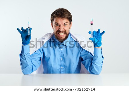 Evil doctor, syringes in the hands, children's fear of doctors