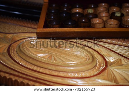 Yellow dices on a wooden carved board