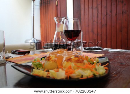 An appetizer called Potato slipper with potatoes baked with yellow cheese, decorated with carrots and cabbage