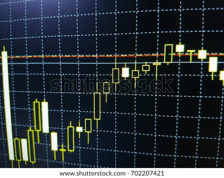 Abstract financial trading graphs on monitor. Background with currency bars and candles