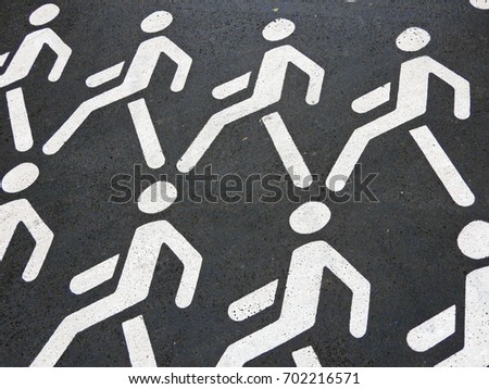 A pedestrian crossing sign in the form of walking men.