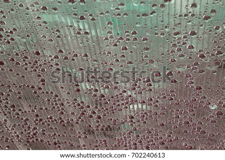 Shiny sparkling, shimmering contrasting drops - spheres half in shadow on the striped canvas bright striking original  background