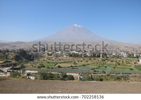 Arequipa city, Misti volcano with the green field around the city of Arequipa, on a sunny day during the dry season, during the afternoon Royalty-Free Stock Photo #702258136