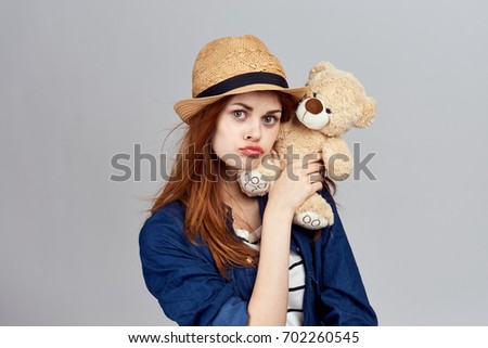 A girl with a bear in her hands