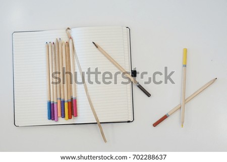 Colored Pencils and Blank Notebook