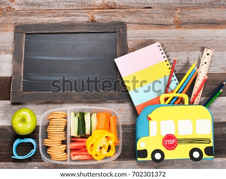 School supplies and lunch on wooden background. Back to school