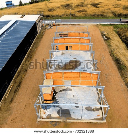 Aerial picture of a building site, taken up with the drone, construction of a hall