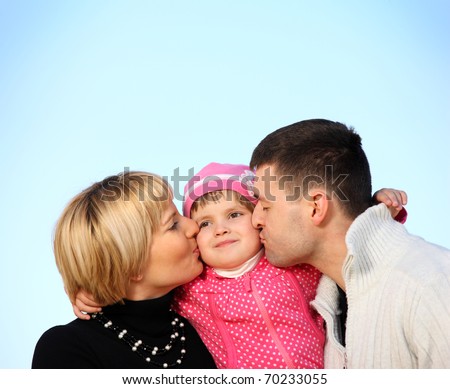 A picture of parents kissing their little girl over blue sky, a lot of space for text