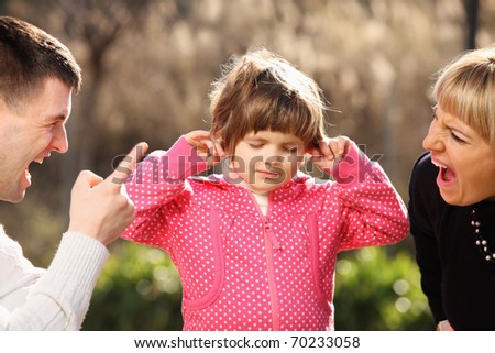 A picture of parents shouting at a little girl in the park
