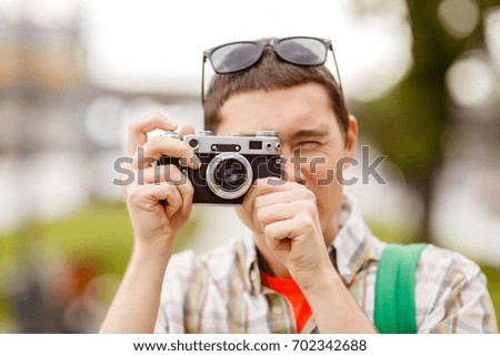 Photo of man with camera in summer on street in afternoon city