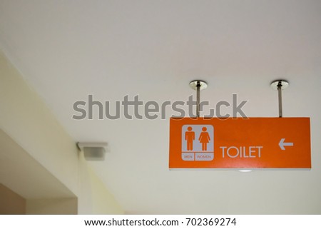Restroom sign Hanging on the ceiling in the department store. image for sign and symbol object.