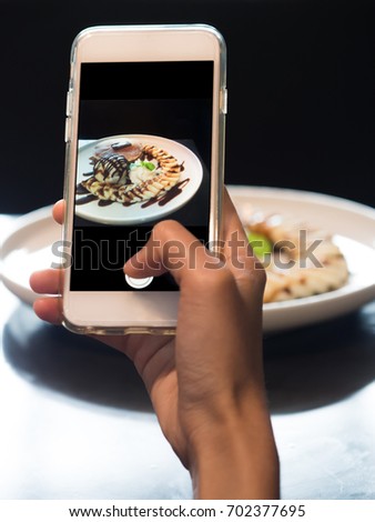 Hand Close up, Hand Holding Smart Phone and Taking Photo of Nice Dessert Banana Pancake.